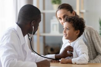 image of doctor examining child.