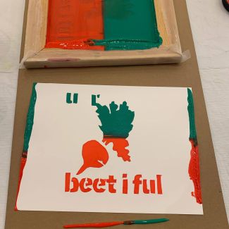 photo of a screenprinted image of a beet in orange and green, with the words, beetiful on it. 