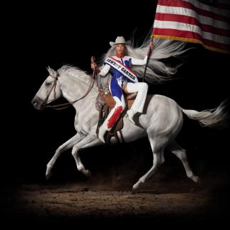 Beyonce with a white horse and cowboy hat against a black background