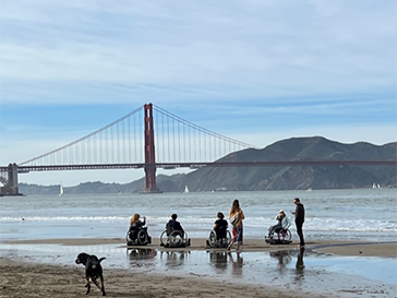 Able-bodied people and people in wheelchairs on the sand at Rosalita Beach (Albany, CA)