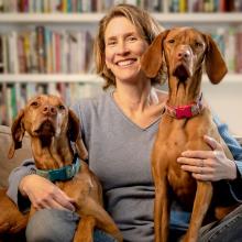 Bethanie Murguia headshot with two large dogs